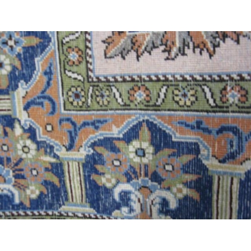 482 - Blue and cream ground patterned prayer rug having a central design with flowers in an urn flanked by... 