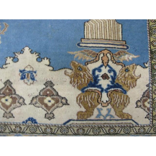 482 - Blue and cream ground patterned prayer rug having a central design with flowers in an urn flanked by... 