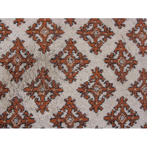 483 - Pair of Tunisian cream and orange ground patterned rugs both having a repeating geometric pattern an... 