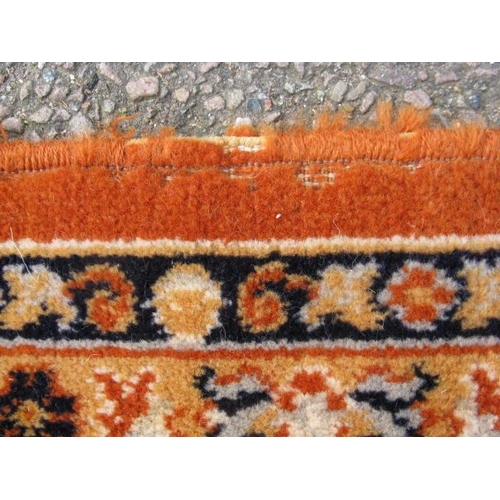 484 - Large Kamar orange ground patterned rug having a central stylized floral motif surrounded by five pa... 