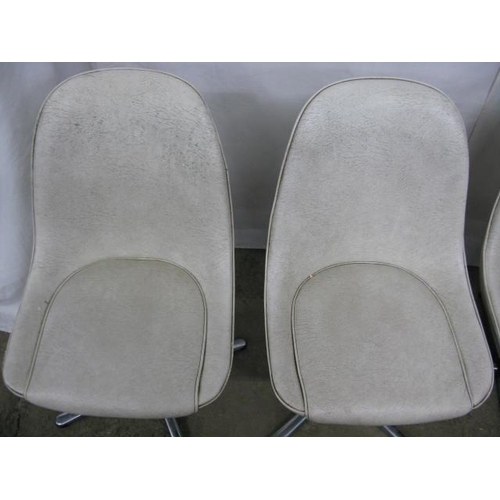 493 - Set of four Centa swivel dining chairs having padded leatherette seats and backs, standing on metal,... 