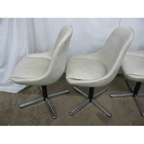 493 - Set of four Centa swivel dining chairs having padded leatherette seats and backs, standing on metal,... 