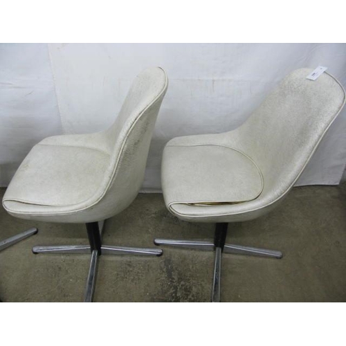 493 - Set of four Centa swivel dining chairs having padded leatherette seats and backs, standing on metal,... 