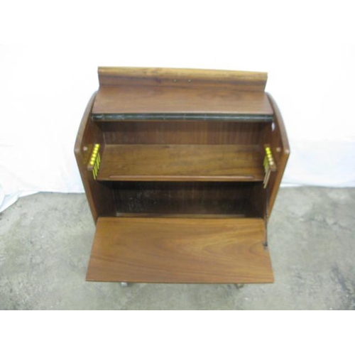 497 - Mid century drinks cabinet having a hinged lift top lid and fall front opening to a shelf and storag... 