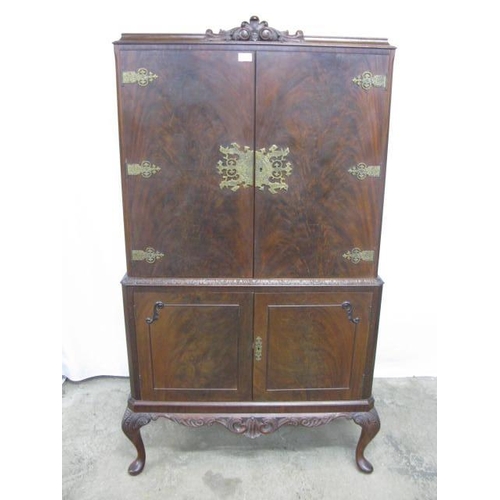 380 - Mahogany drinks cabinet, the top section having two doors opening to a maple lined interior with mir... 