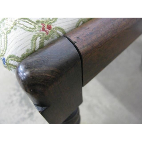 500 - Ebonised rocking chair having a cane panel back and seat, standing on stretchered turned legs with r... 