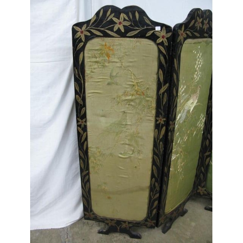 502 - Four fold screen having black and gilt foliate painted frames with padded inset panels with needlepo... 