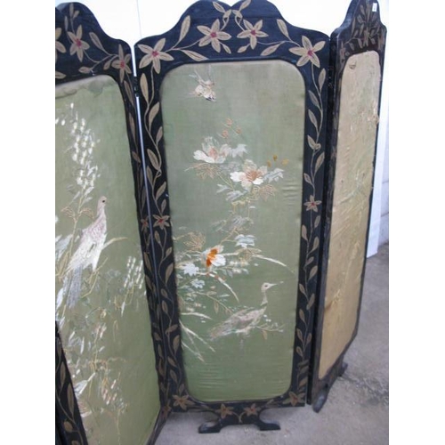 502 - Four fold screen having black and gilt foliate painted frames with padded inset panels with needlepo... 