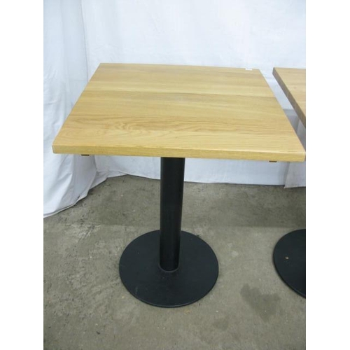 505 - Set of three Warings Furniture bistro tables, the square oak tops standing on round metal columns wi... 