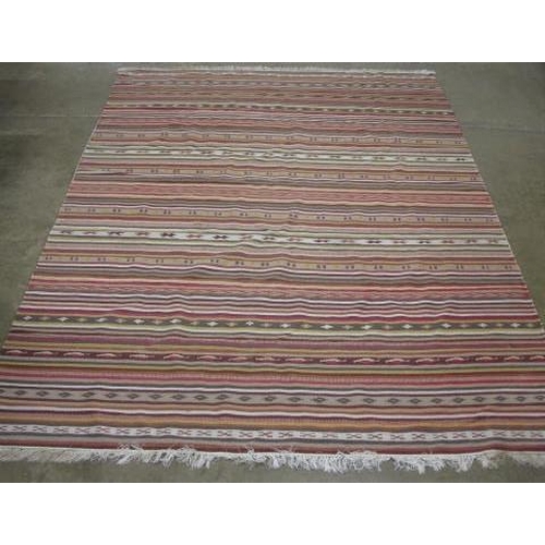 506 - Stripey patterned rug with geometric repeating motifs and end tassels - 2.98m x 2m