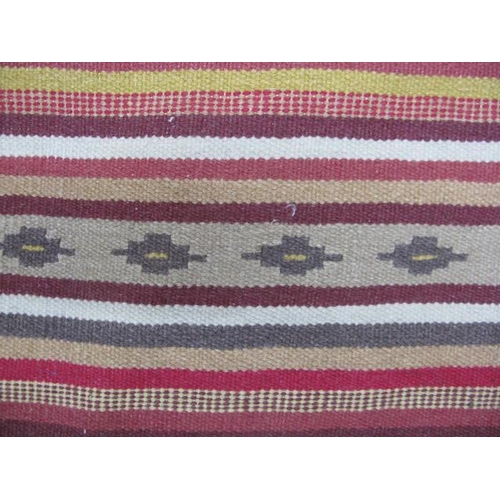 506 - Stripey patterned rug with geometric repeating motifs and end tassels - 2.98m x 2m