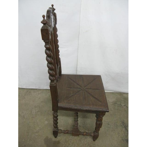 509 - Carved oak hall chair having a pierced carved splat decorated with vines and grapes with barley twis... 