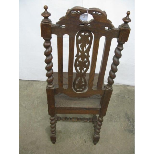 509 - Carved oak hall chair having a pierced carved splat decorated with vines and grapes with barley twis... 