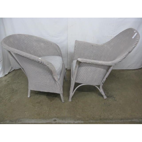 518 - Two painted Lloyd Loom chairs both having shaped backs and padded seats, standing on round tapering ... 