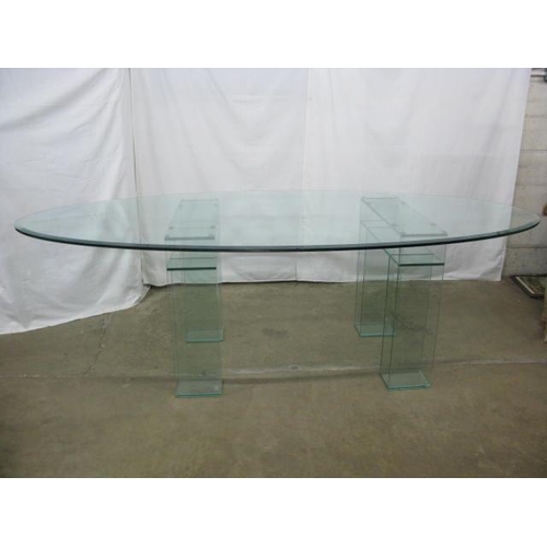 526 - Oval glass top dining table standing on two glass supports - 245cm x 108cm x 74cm tall (chips to edg... 