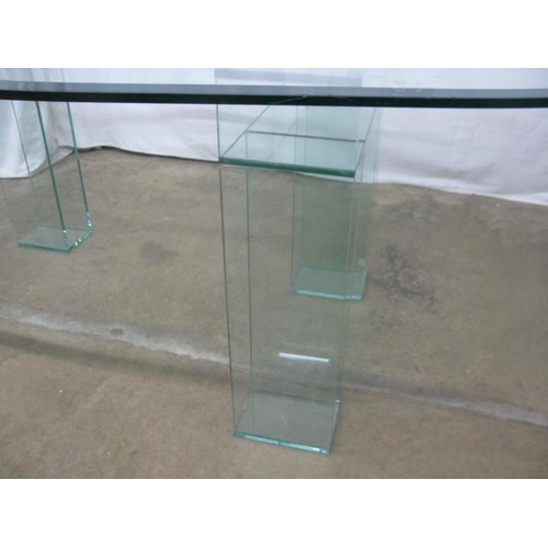 526 - Oval glass top dining table standing on two glass supports - 245cm x 108cm x 74cm tall (chips to edg... 