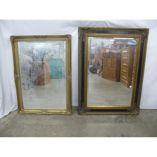 533 - Ornate gilt and black bevelled edge mirror - 84cm x 5cm x 116cm together with an ornate gilt bevelle... 