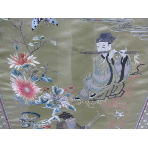 534 - Three Oriental embroidered silks all having a central panel decorated with figures, trees, flowers a... 