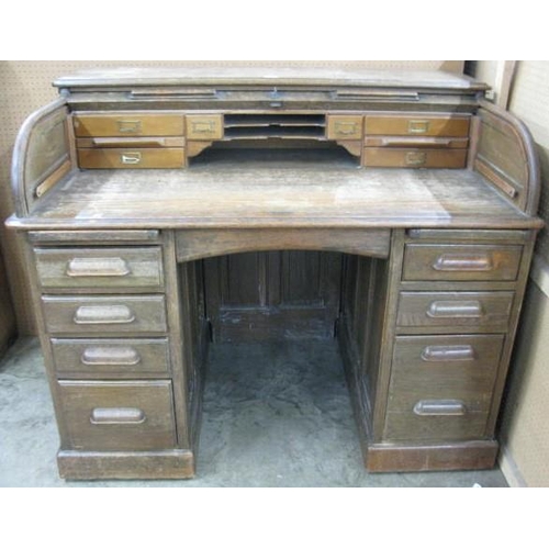 539 - Twin pedestal roll top desk, the desk having an arrangement of pigeon holes and drawers over a centr... 