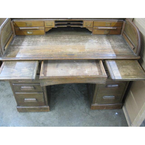 539 - Twin pedestal roll top desk, the desk having an arrangement of pigeon holes and drawers over a centr... 