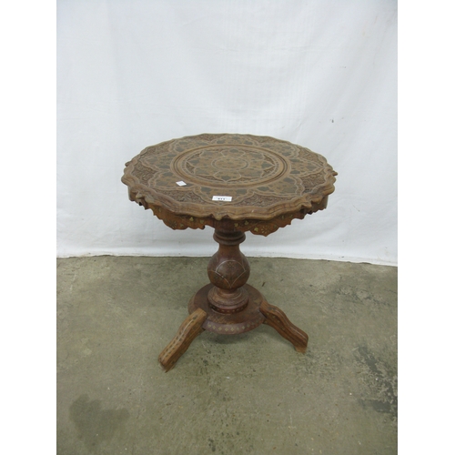 411 - Carved hardwood table having a shaped top with foliate brass inlay, standing on a turned column with... 