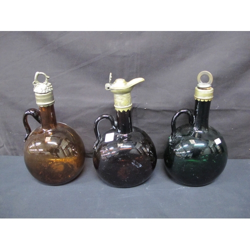 82 - Three coloured glass flagons, two with metal stoppers and collars and one with a metal collar and po... 