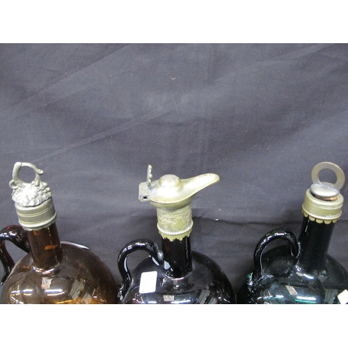 82 - Three coloured glass flagons, two with metal stoppers and collars and one with a metal collar and po... 