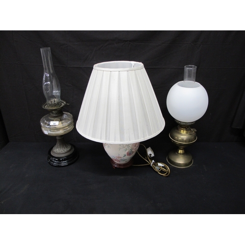 68 - Two oil lamps together with a table lamp