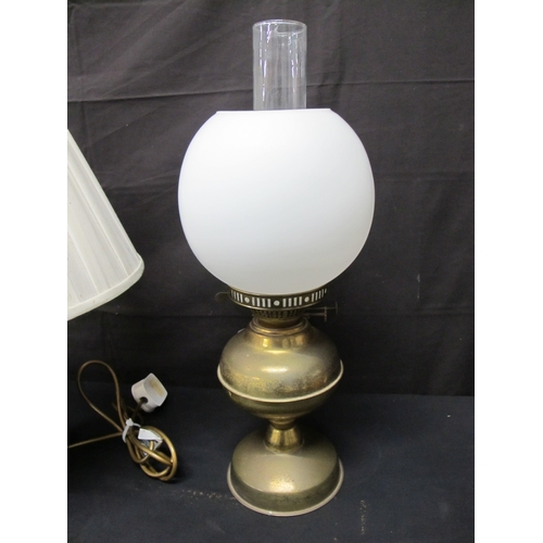 68 - Two oil lamps together with a table lamp