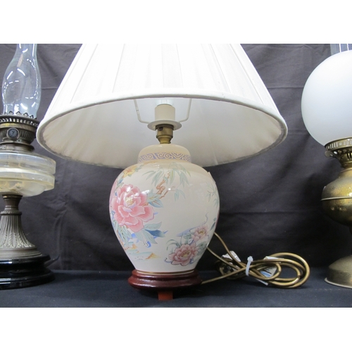 68 - Two oil lamps together with a table lamp