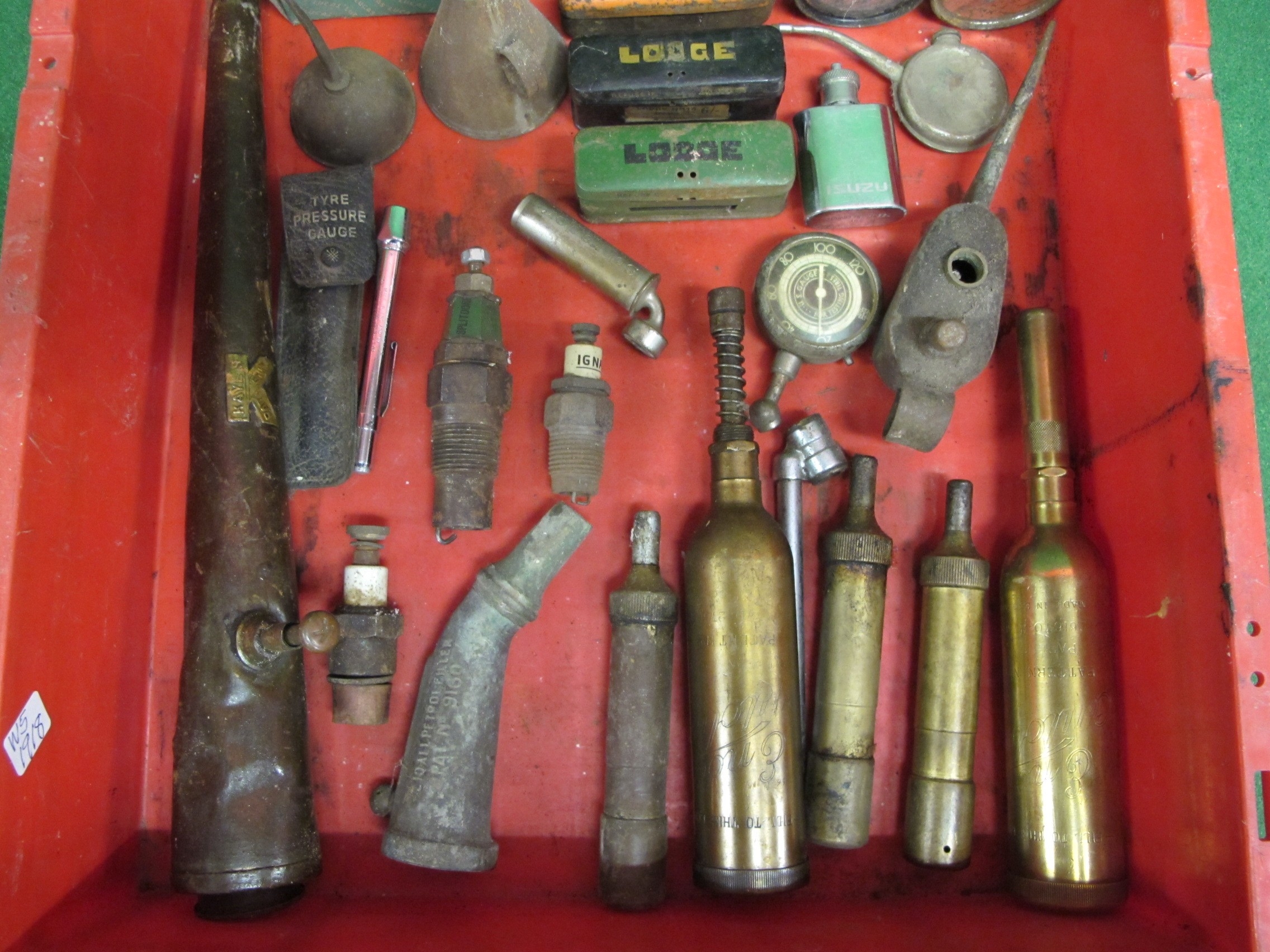 Tray of grease guns, oil cans, large spark plugs, tins, carbide ...