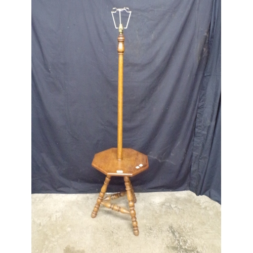 248 - Oak arts and crafts standard lamp, having turned column leading to a gypsy style table base, support... 
