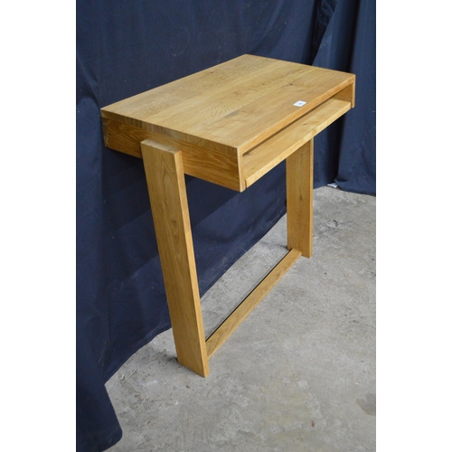 256 - Light oak wall mounted writing table, having pull slide supported on stretchered moulded uprights - ... 