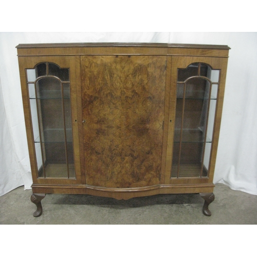 289 - Walnut display cabinet having a central bow front door, the door opening to two shelves, flanked by ... 