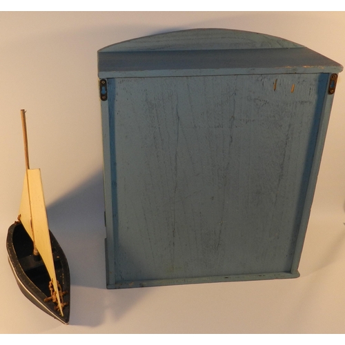 262 - Blue wooden unit with a wooden boat model