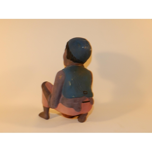 303 - Statue of a boy holding a bag of money, resin apx 23.5cm