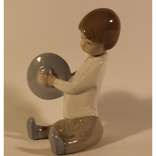 47 - Lladro Porcelain Figure of a Boy Playing Cymbals in mint condition, 15 cm tall