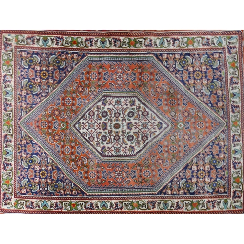 82 - A fine Bidjar rug with geometric floral motifs within double diamond medallion, on a red,blue and be... 