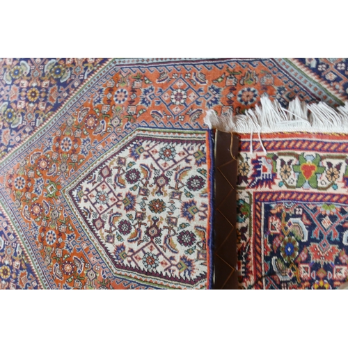 82 - A fine Bidjar rug with geometric floral motifs within double diamond medallion, on a red,blue and be... 