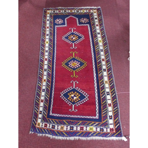 93 - A 20th century Shirvan rug, with 3 geometric medallions on a red ground, contained by geometric bord... 