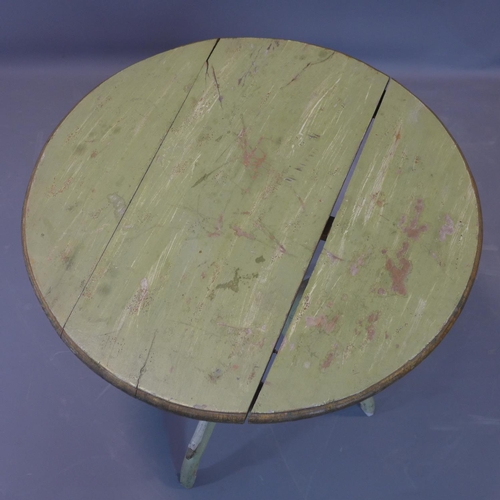 24 - A distressed painted circular table, on outswept legs, H.69cm Diameter 69cm