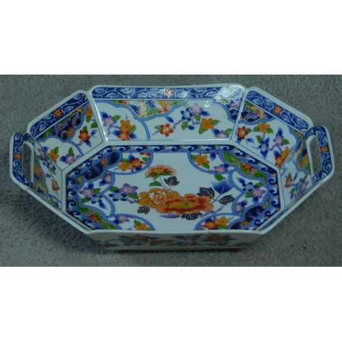 31 - A transfer design oriental handled serving dish. Printed artists seal to base. Decorated with floral... 