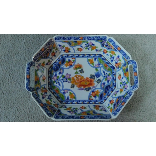 31 - A transfer design oriental handled serving dish. Printed artists seal to base. Decorated with floral... 