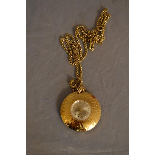 45 - A vintage Tegrov gold tone pendant antimagnetic watch and chain. Impressed floral design to the back... 