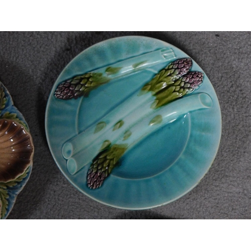 14 - Four antique majolica plates. One designed by George Jones of pineapples in a basket, the waterlilly... 