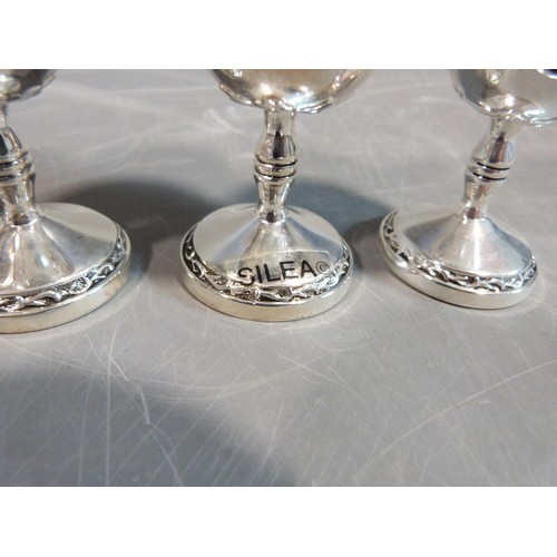 10 - A set of six white metal silea vine design kiddush cups. H.8cm.
