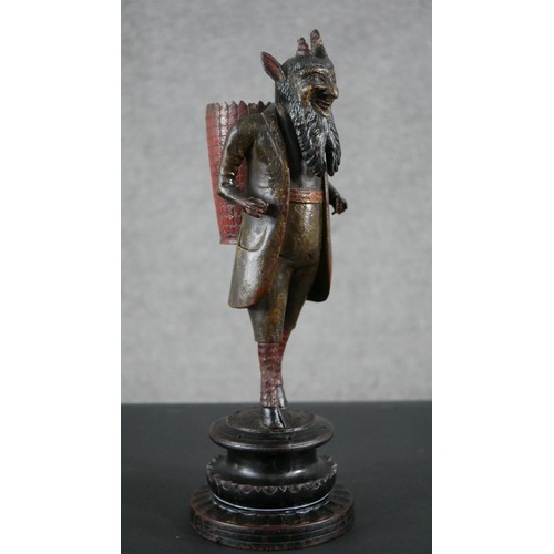 5 - A 19th century carved black forest faun match holder, a pedestal base with red basket on his back. H... 