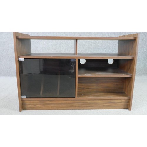 214 - A circa 1970s walnut record cabinet, with an arrangement of shelves and recesses, and a smoked glass... 