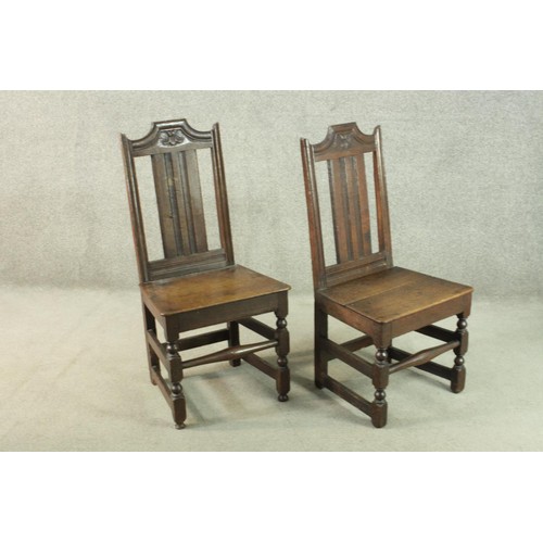 270 - A pair of 19th century country oak dining chairs, the back carved with a flowerhead, over solid seat... 
