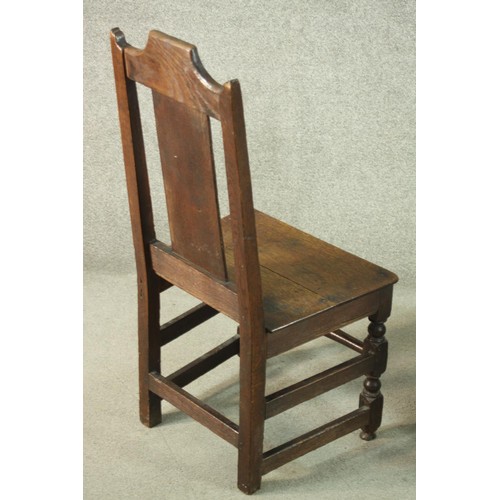 270 - A pair of 19th century country oak dining chairs, the back carved with a flowerhead, over solid seat... 